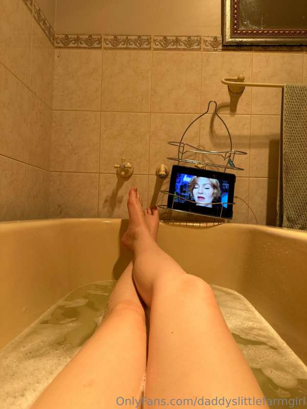 Baby girl caught the flu.  In the bath tub trying to feel be..