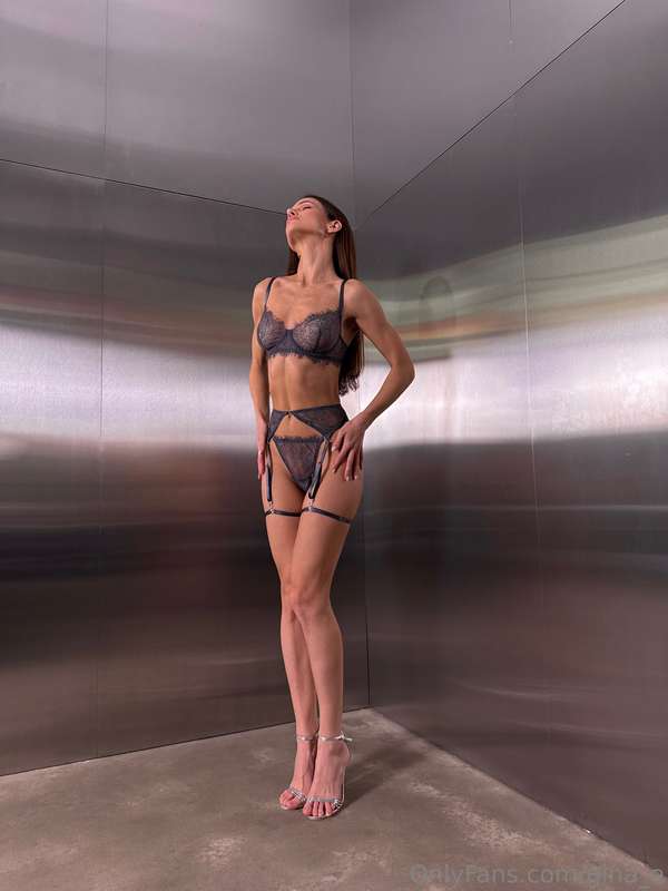 Heels off, toes in soft carpet, still wearing the lingerie f..