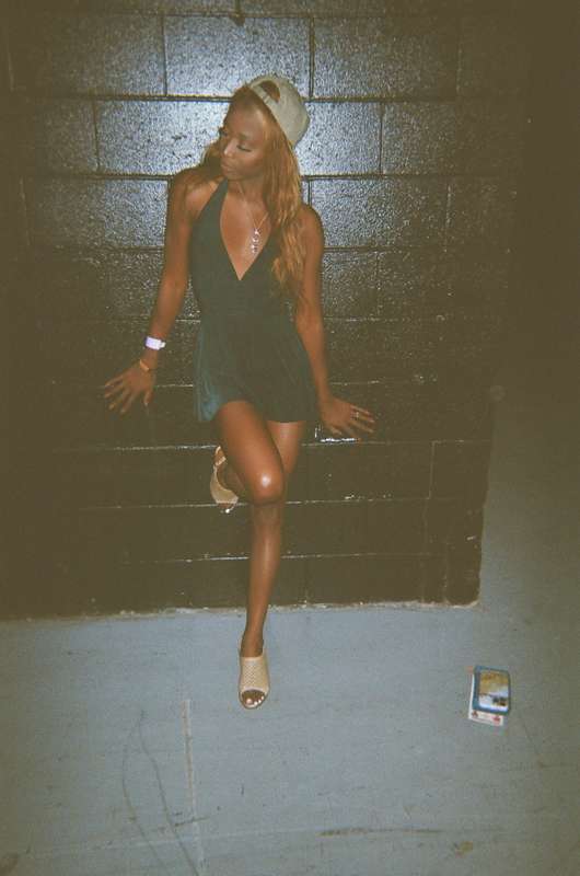 green dress hugging me tight, cap keeping it casual, heels e..