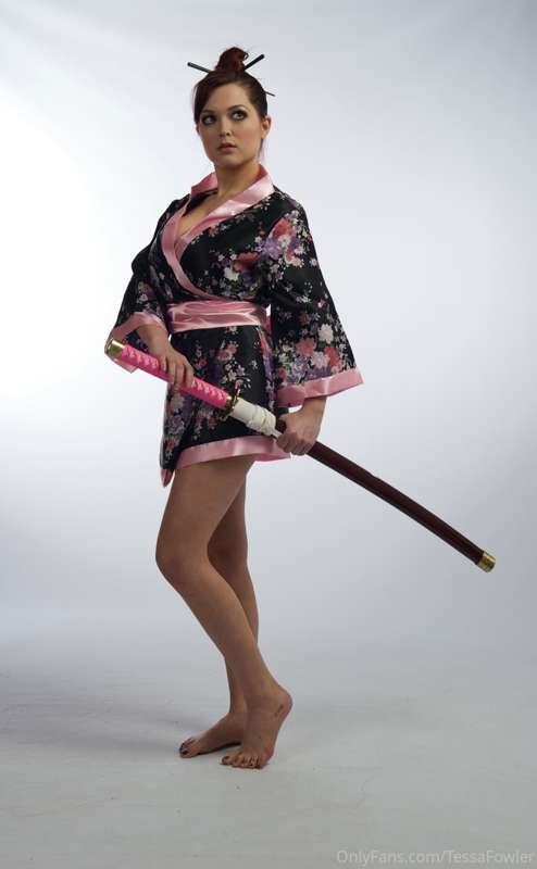 silly caucasian girl likes to play with samurai swords