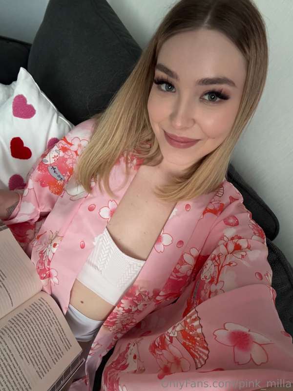 A cozy evening in a pink kimono: a book, a pillow with heart..