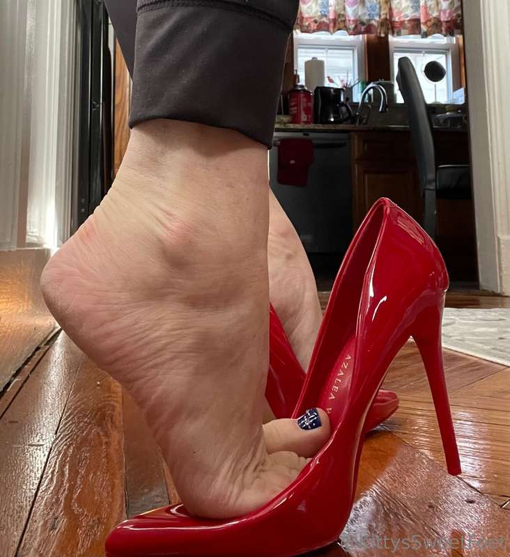 The allure of dangling red stiletto pumps lies in the tantal..